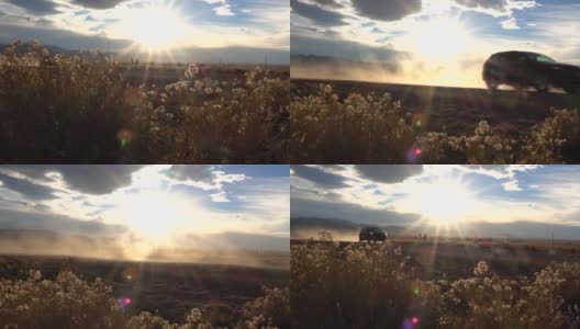 低角度:当SUV穿越新墨西哥沙漠时，尘土从空旷的高速公路上升起高清在线视频素材下载
