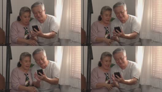 4K亚洲老夫妇坐在楼梯上，一起使用手机高清在线视频素材下载