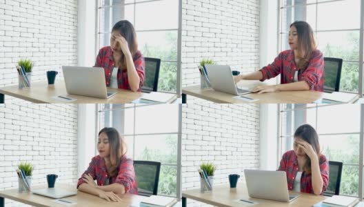 经济衰退压力女性使用笔记本电脑在家办公头痛，疲惫的失败业务挫折。压力大的亚洲女性焦虑过度工作，痛苦与生活危机累压力大的失业高清在线视频素材下载