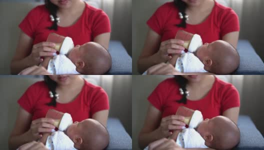 亚洲妇女在家里给婴儿喂奶高清在线视频素材下载