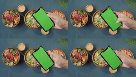 夏威夷戳碗，手持智能手机与彩色绿色屏幕顶部视图。由切成片的蔬菜、海鲜和绿叶植物制成的熟戳。健康的素食。亚洲素食生食，筷子高清在线视频素材下载