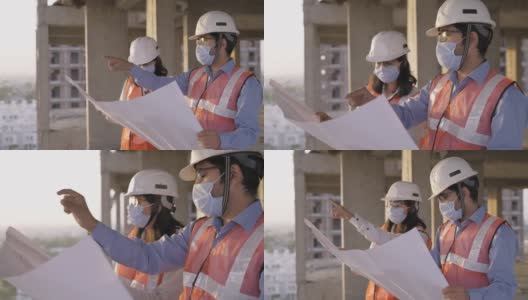 一男一女戴着防护口罩的土木工程师在讨论项目高清在线视频素材下载