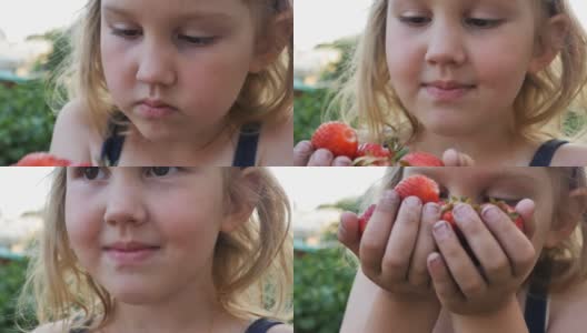 一个可爱的十几岁的女孩手里拿着许多新鲜的草莓，用鼻子嗅着草莓，把它带到脸上。缓慢的运动。特写镜头高清在线视频素材下载