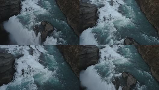 从直升机上鸟瞰美丽而有力的海湾瀑布。冰岛风景优美的水和悬崖高清在线视频素材下载