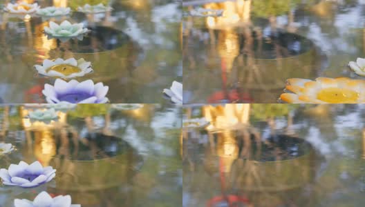 美丽的金色佛像在水中倒影，上面漂浮着各种各样的蜡烛，莲花的形式高清在线视频素材下载