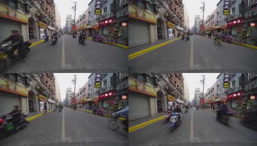 中国人骑着摩托车在拥挤的街道上行走。高清在线视频素材下载