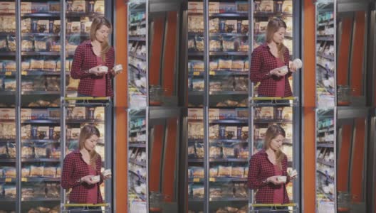 一位美国年轻女子站在杂货店的室内，正在选购乳制品高清在线视频素材下载