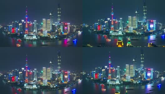 无人机拍摄上海金融区大楼的4K鸟瞰图，带led广告屏幕视图附近的东方明珠塔，中国上海。晚上的时间高清在线视频素材下载