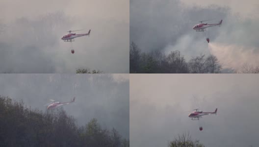 SLO MO直升机与消防员在森林大火中泼水高清在线视频素材下载