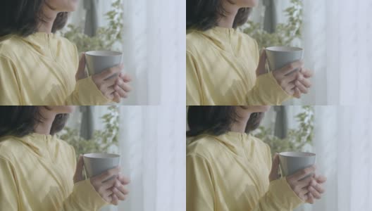 手持。手握咖啡在家里早上女人的近距离高清在线视频素材下载