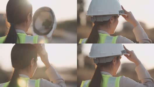 慢镜头近距离的一个女工程师把一个建筑头盔在日落，成功，工作和工程概念。高清在线视频素材下载