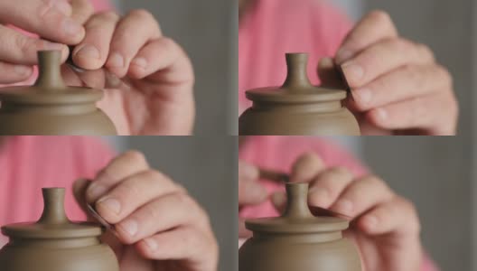 特写镜头。专业陶工在陶工轮上塑造泥茶壶的壶盖。陶瓷艺术的概念。手工制作的陶器。陶工制作粘土制品高清在线视频素材下载