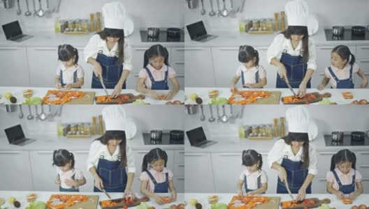 4K妈妈和她的小女儿在厨房准备午餐高清在线视频素材下载