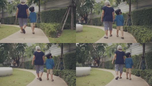 奶奶和孙子在公园里散步。高清在线视频素材下载