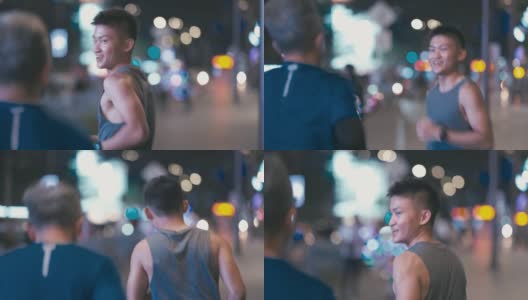 一名亚裔中国男子鼓励他的父亲晚上下班后一起在城市里慢跑高清在线视频素材下载