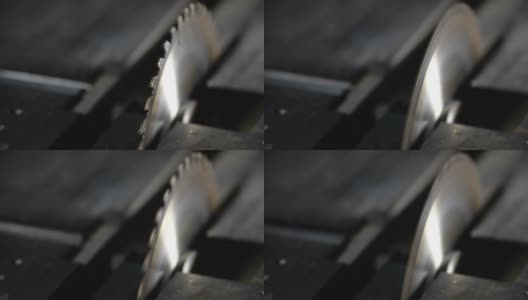 在一个小型家具制造厂的木工车间里，以每秒200帧的慢动作在金属桌子上旋转圆锯。木工、细木工高清在线视频素材下载