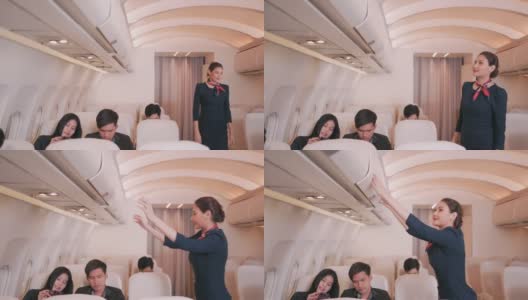 亚洲飞机女乘务员检查完毕在飞机上关闭行李舱，商务舱起飞前。4 k UHD片段。高清在线视频素材下载