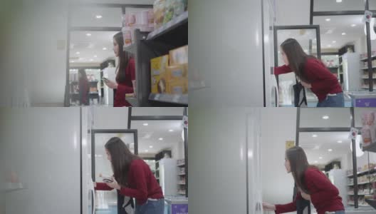一名亚洲女商人身穿红色便装，正在一家杂货店购买商品和服务高清在线视频素材下载