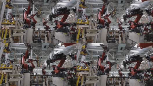 在现代工厂里，机器人将零件安装和焊接到车身上高清在线视频素材下载