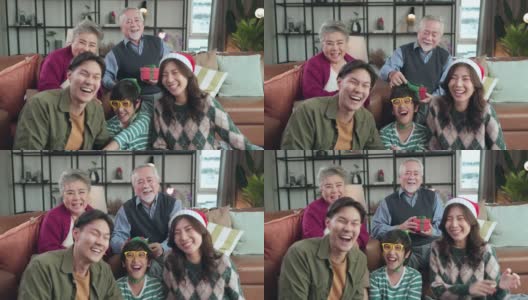 快乐的圣诞感恩节周末，多代亚洲家庭拜访祖父母坐在一起放松大笑微笑乐趣和快乐的美妙时刻在家里客厅，pov亚洲家庭在一起高清在线视频素材下载