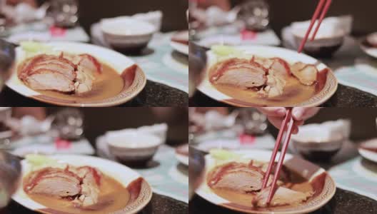 用筷子夹烤鸭的特写高清在线视频素材下载