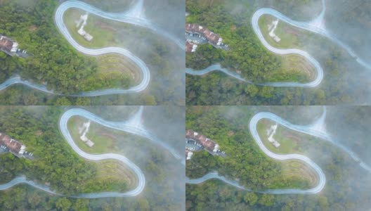 鸟瞰图公路旅行或蜿蜒的道路在森林卡梅伦高地，布林昌，马来西亚高清在线视频素材下载