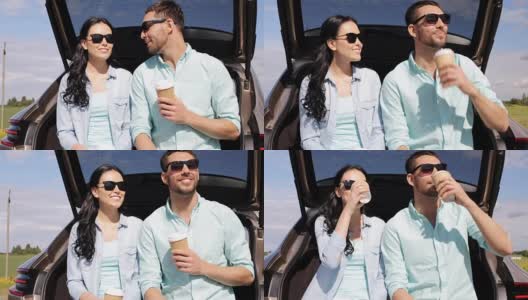 一对幸福的夫妇在车后车厢喝咖啡高清在线视频素材下载
