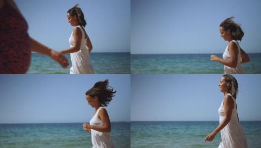 快乐的年轻女子在海滩上奔跑高清在线视频素材下载