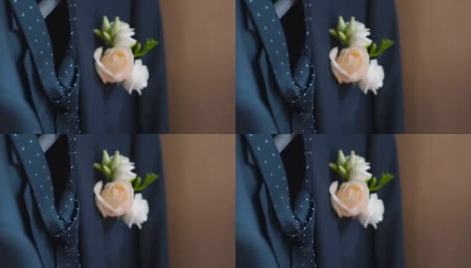 在婚礼当天，新郎夹克口袋里的胸花。夹。玫瑰在他的夹克口袋里高清在线视频素材下载