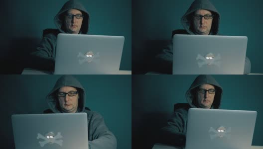 成年人在电脑上浏览互联网。一个人深夜坐在桌子旁，拿着笔记本电脑。他的时尚眼镜屏幕上的闪光。电脑屏幕反映在一个年轻人的眼镜上。缓慢的运动。高清在线视频素材下载