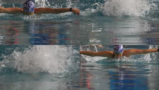 慢动作:女运动员蝶泳式游泳。女子游泳运动员参加游泳比赛。高清在线视频素材下载