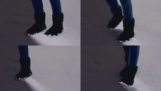 一个跳来跳去取暖的小女孩的腿。这个女人在一个冰雪覆盖的冬季公园里冻死了高清在线视频素材下载