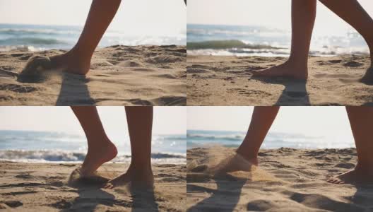 近距离的女性的脚走在金色的沙滩与海浪的背景。年轻女子的双腿踩在沙子上。光着脚的女孩在海边。暑假或假日概念。慢动作低角度视图侧视图高清在线视频素材下载