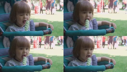 小男孩在公园的户外吃冰淇淋高清在线视频素材下载