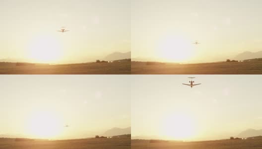 低角度视角:客机在机场上空飞向日出高清在线视频素材下载
