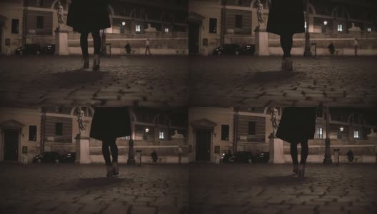 女性的脚在晚上走过荒芜的街道的特写镜头。孤独的女人回家晚了高清在线视频素材下载