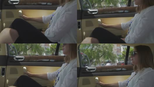 漂亮女人坐在豪华轿车的后座上，微笑着看着车窗高清在线视频素材下载