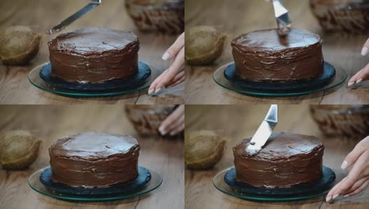 糕点师在蛋糕上涂上巧克力奶油。高清在线视频素材下载