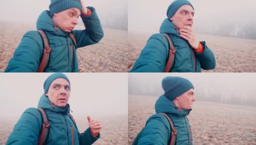 一个男人用牙齿脱下手套，在雾中寻找一个走失的孩子。高清在线视频素材下载