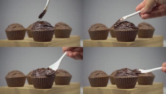 棕色巧克力松饼放在木板上，涂上融化的巧克力高清在线视频素材下载