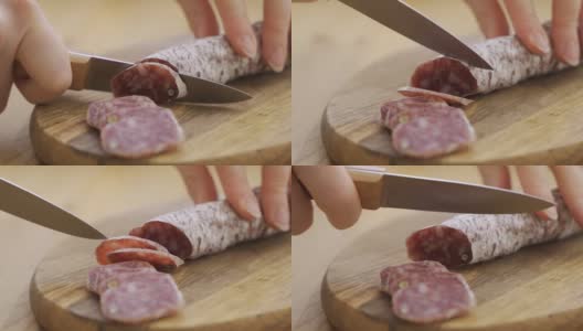 在厨房的木板上把西班牙传统自制香肠切成小块高清在线视频素材下载