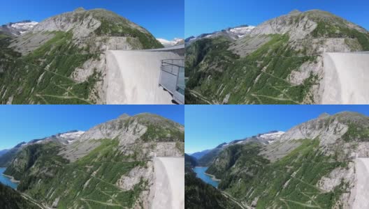 从奥地利卡林西亚Koelnbrein大坝上俯瞰山谷的全景。大坝被高山环绕着。陡峭的斜坡。山谷底部有一个长湖。自然能源高清在线视频素材下载