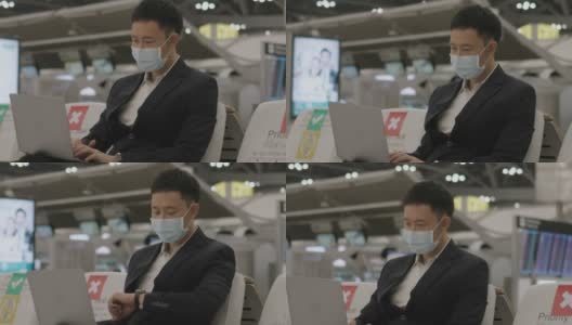 亚洲精力充沛的商人，戴着防护面罩，在等待飞机到达时接听在线工作电话-库存视频高清在线视频素材下载