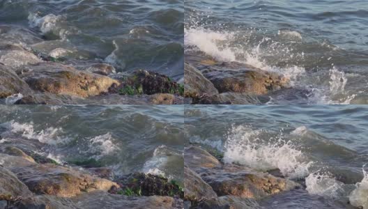 飞溅的水珠落在海滩上的悬崖上高清在线视频素材下载