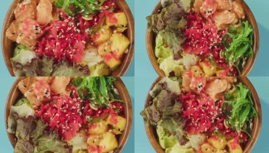 蓝色背景上的Poke碗沙拉。蔬菜切片，红鱼和芝麻。传统的夏威夷美食特写。健康的素食。亚洲素食生餐轮换高清在线视频素材下载