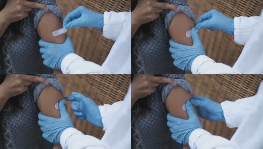 在COVID-19疫苗接种后，医生给患者粘贴绷带高清在线视频素材下载