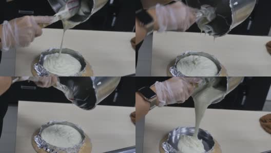 女糕点师用硅胶刮刀将面糊抹在烤盘上高清在线视频素材下载