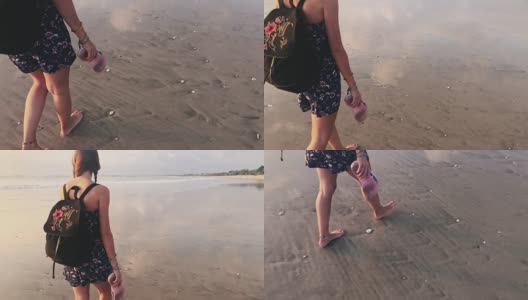 快乐的女人在巴厘岛的沙滩上跑步，印度尼西亚。高清在线视频素材下载