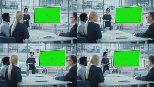 女运营经理为一组经济学家做会议报告。亚洲妇女使用数字白板水平绿色屏幕模拟显示。在商务办公室工作的人。高清在线视频素材下载
