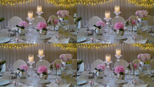 时尚干净的婚礼装饰，粉红色的花朵和烛光高清在线视频素材下载
